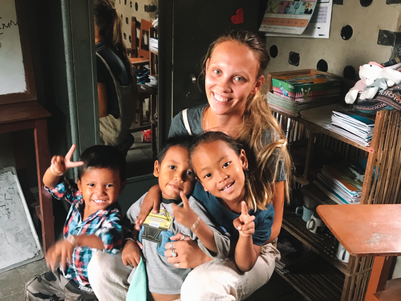 Kindergarten children with Georgina the IVI volunteer