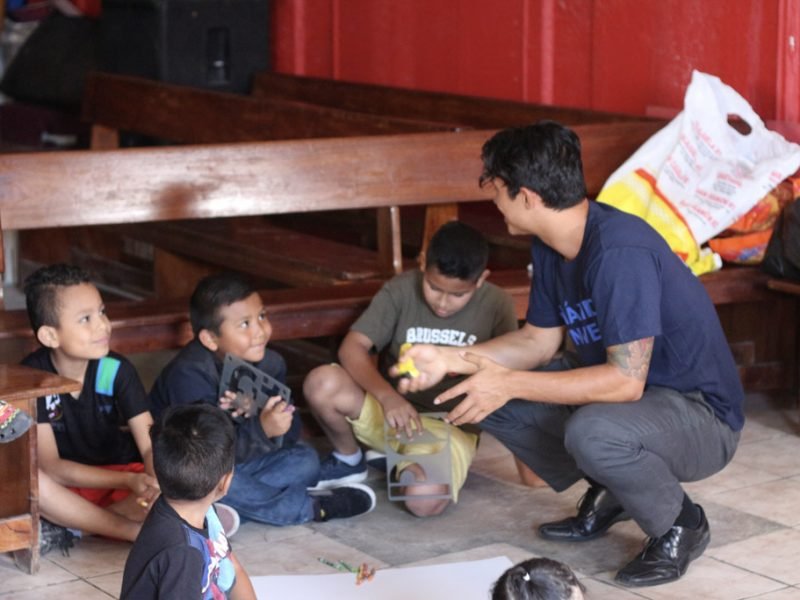 volunteer talking with students